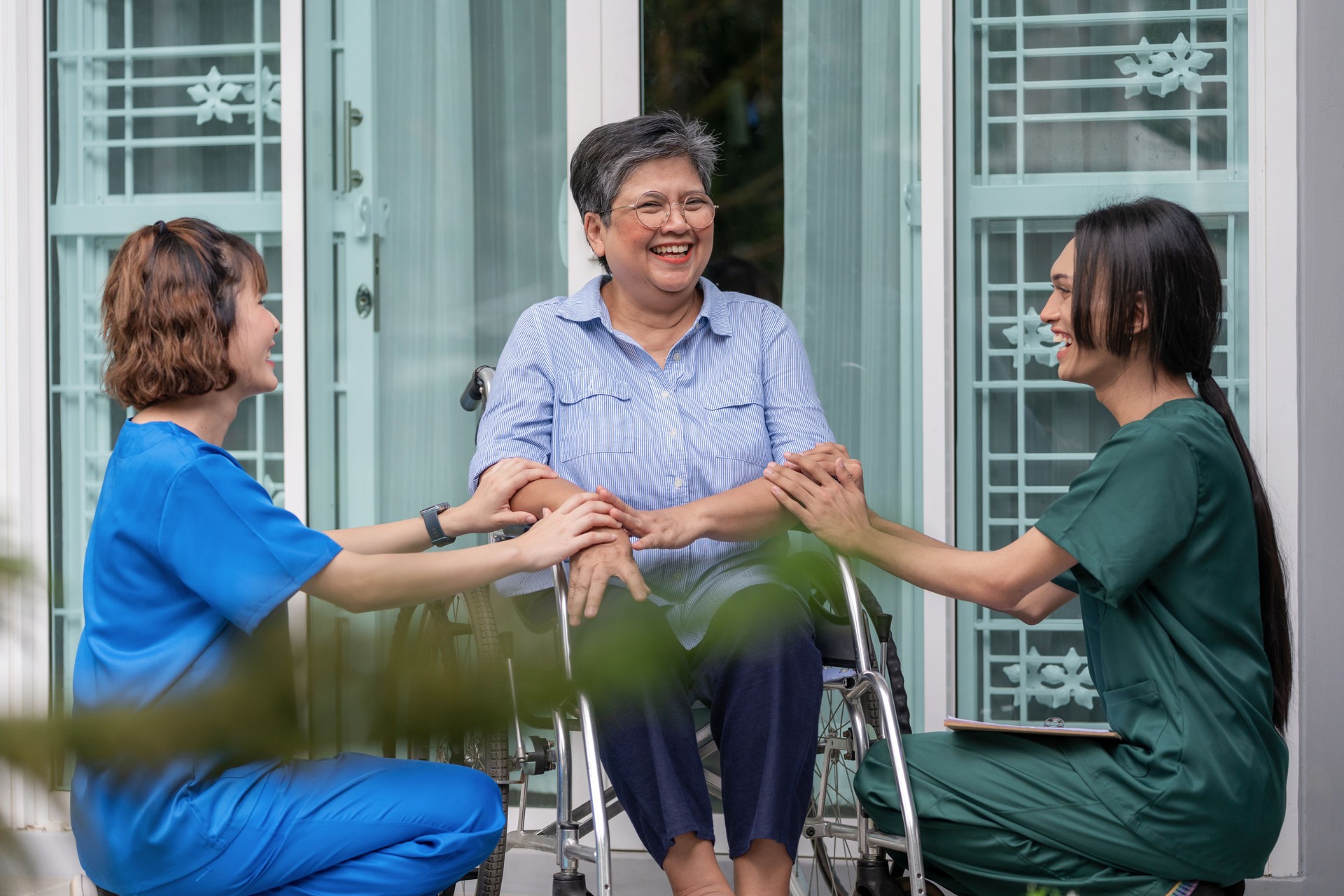 Caregiver and nurse offering compassionate advice to a senior woman on the balcony of her home. A heartwarming scene of emotional support, home care, and togetherness, highlighting healthcare professionals providing assistance, comfort, and expert care.