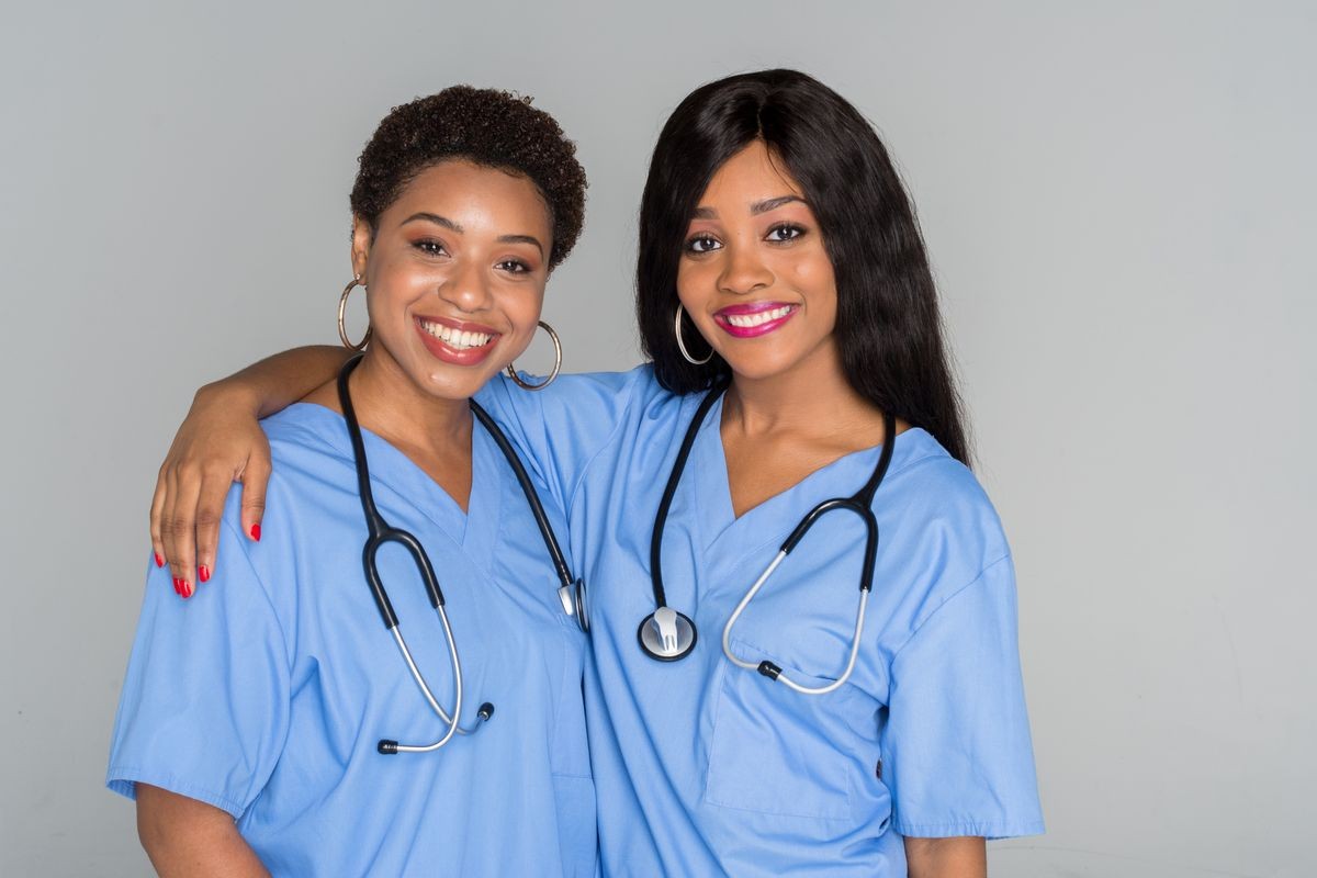 Two African American nurses working their shift in the hospital